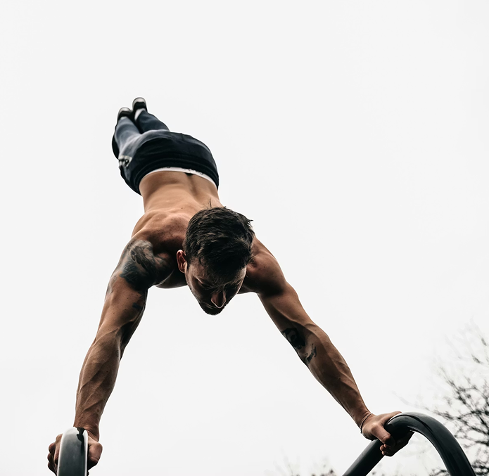 Athlete training on parallettes